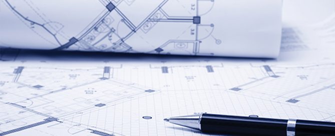 A Pen placed on a set of planning application documents and blueprints