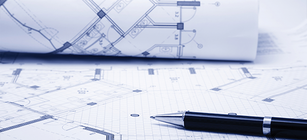 WhatWeDo_PlanningApplications A Pen placed on a set of planning application documents and blueprints