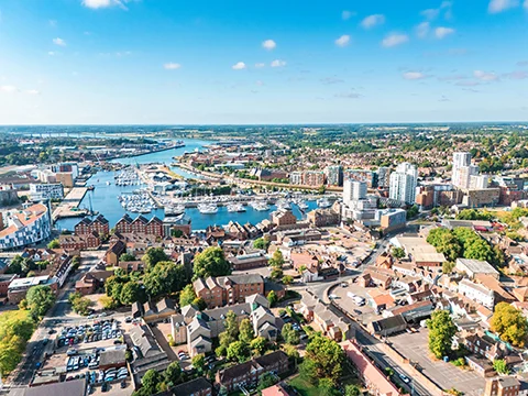 Ipswich waterfront showcasing vibrant marina and cityscape under a clear blue sky Suffolk
